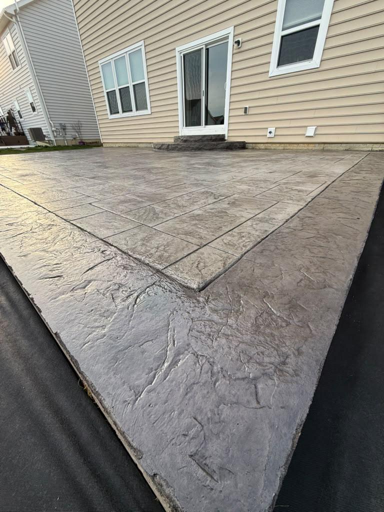 Expansive stamped concrete patio with contrasting border