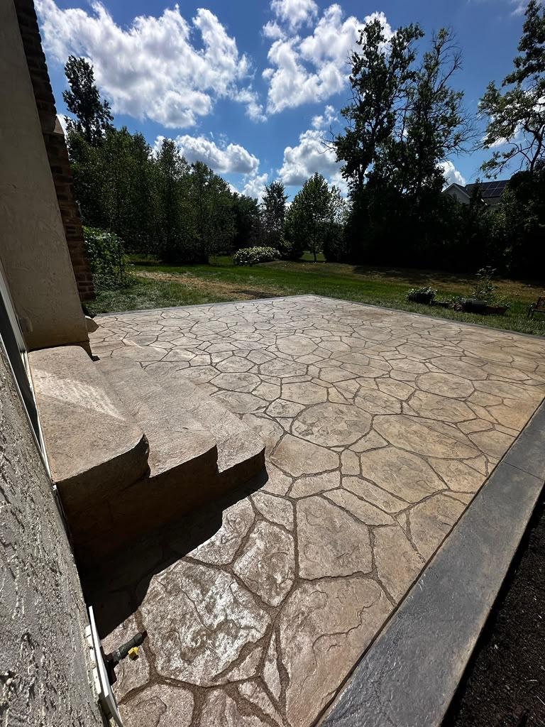 Random flagstone stamped patio with decorative stone border