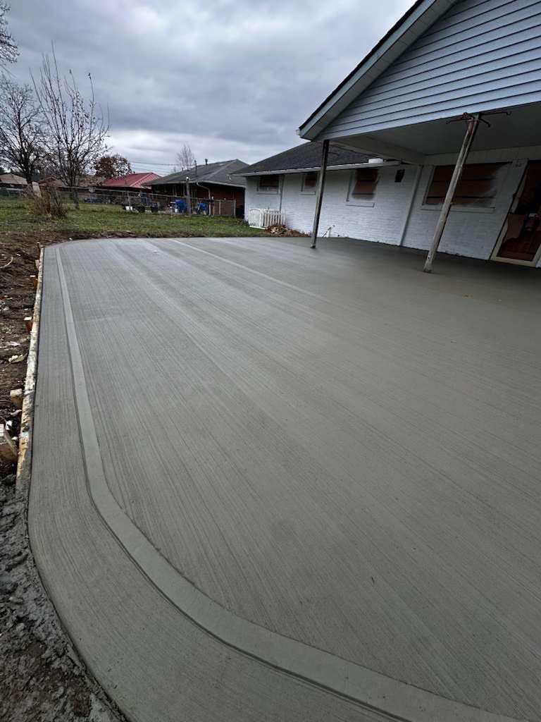 Large covered residential patio with clean broom finish and curved border